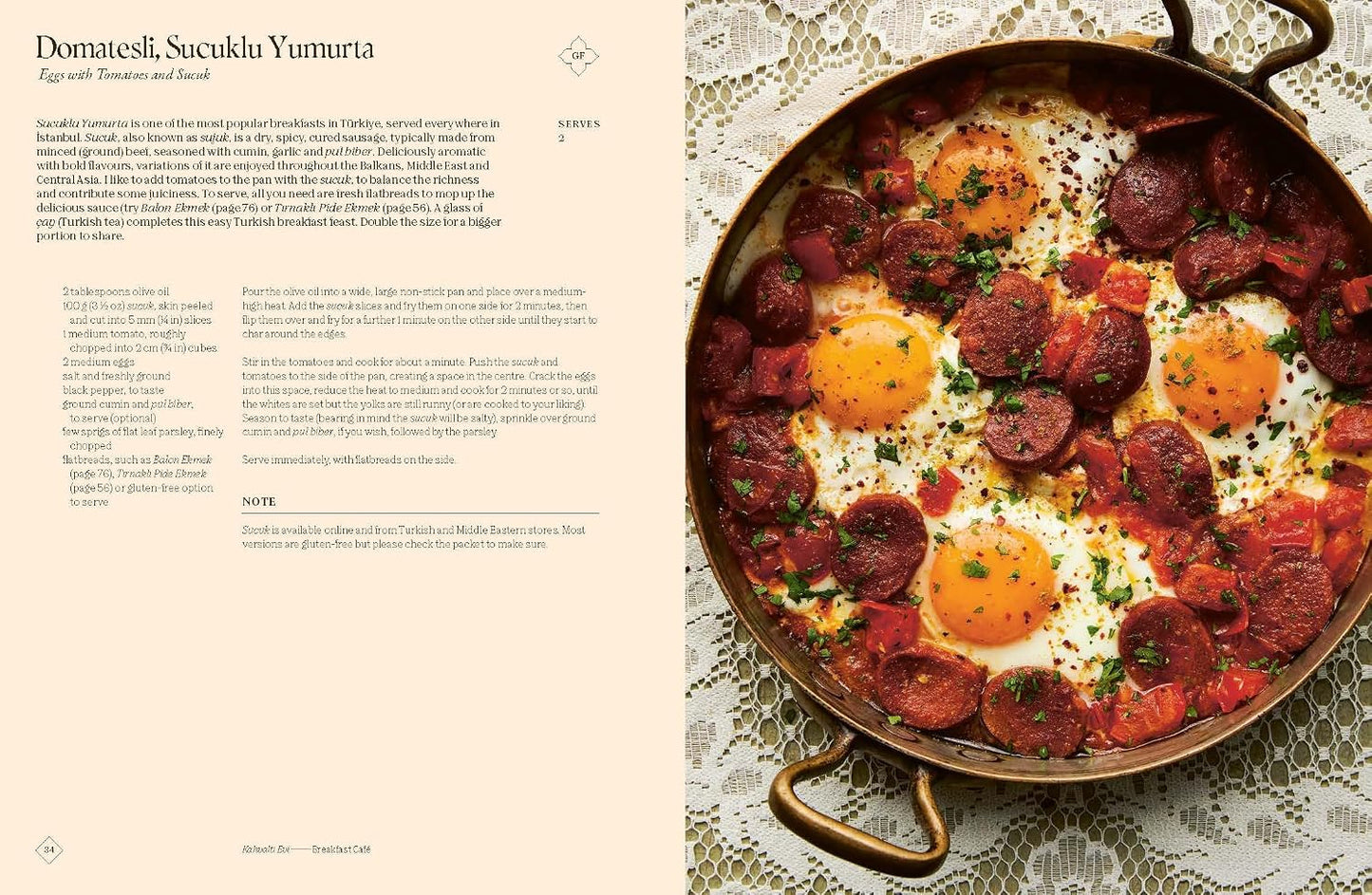 Pan with eggs and sausages on a lace tablecloth