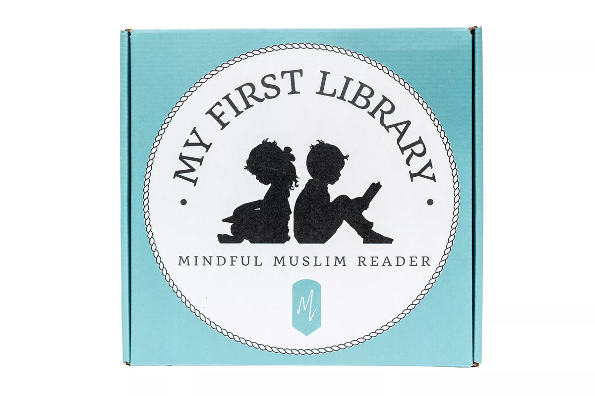 A square light blue cardboard book box with a large white oval label reading 'MY FIRST LIBRARY' and 'MINDFUL MUSLIM READER,' featuring black silhouettes of two children reading and a small mint logo below.