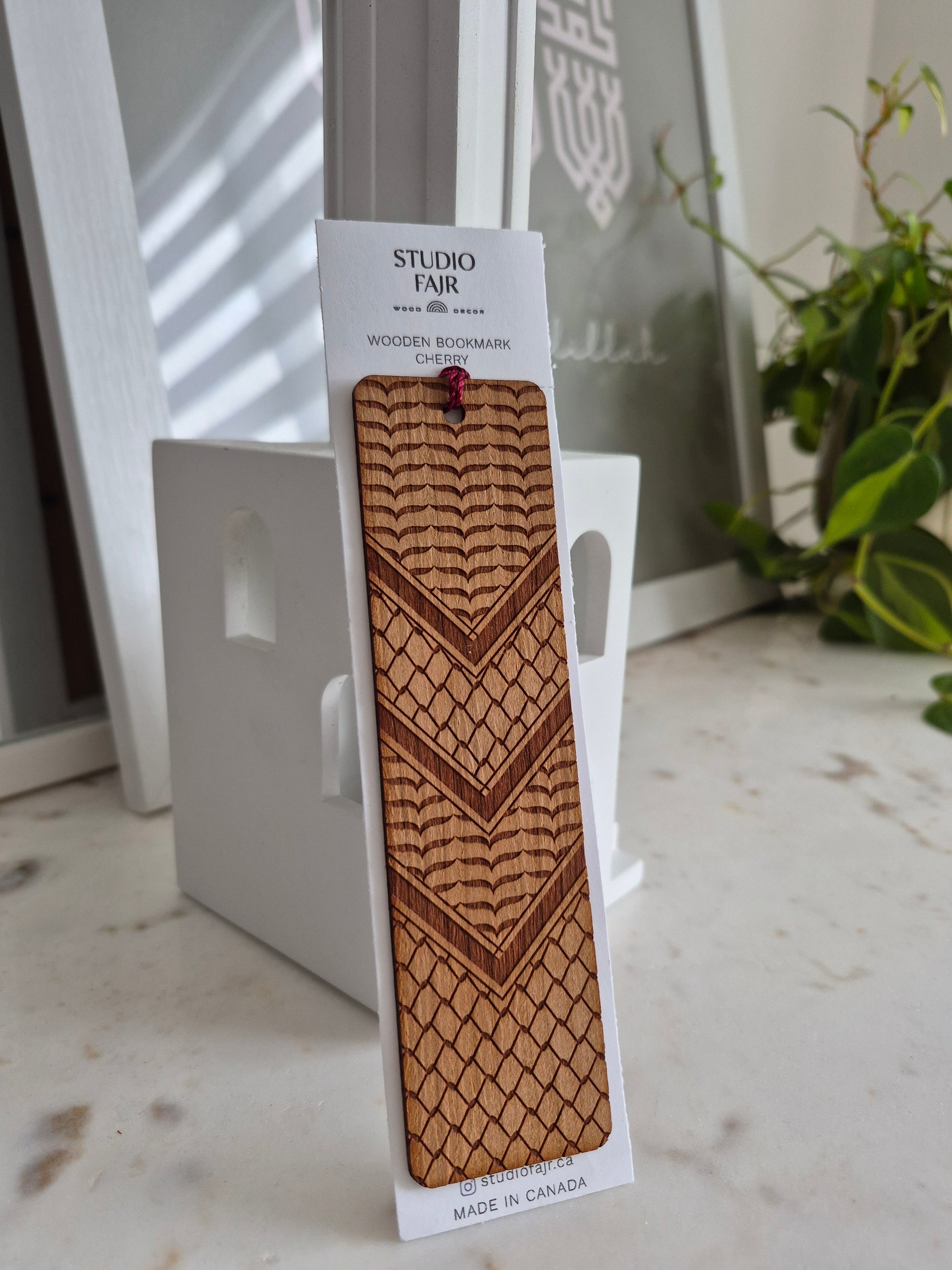 Kuifya Wooden bookmark with geometric pattern on a white stand with a blurred background